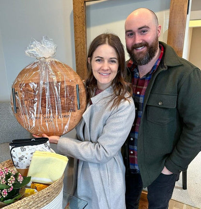 Customers holding their personalized round cherry tray wrapped and ready for gifting