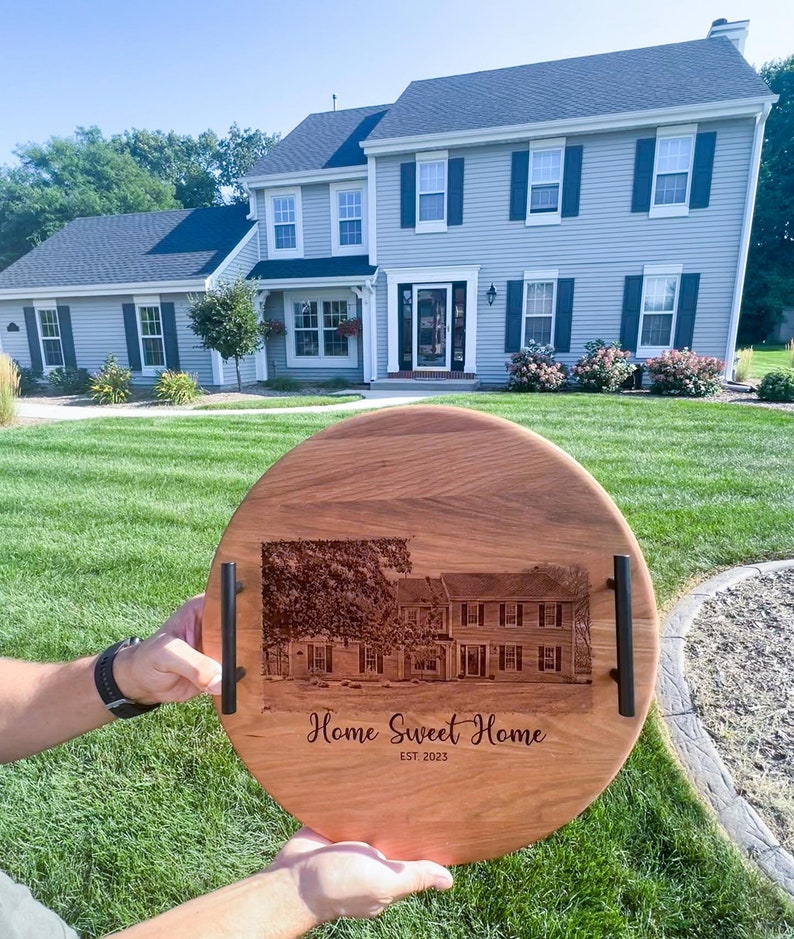 Personalized round cherry tray held in front of the matching house used for the engraving